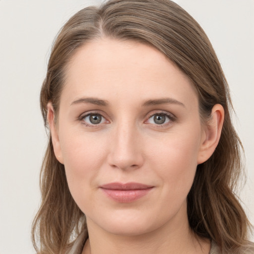 Joyful white young-adult female with long  brown hair and grey eyes