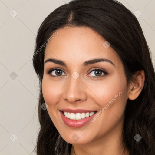 Joyful white young-adult female with long  brown hair and brown eyes