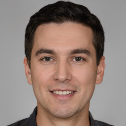 Joyful white young-adult male with short  brown hair and brown eyes