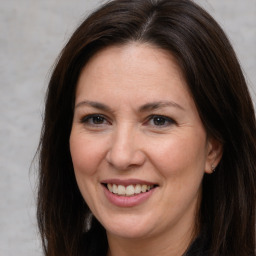 Joyful white adult female with long  brown hair and brown eyes