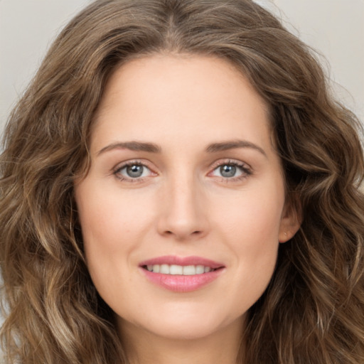 Joyful white young-adult female with long  brown hair and green eyes