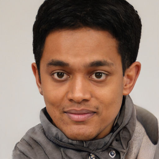 Joyful black young-adult male with short  black hair and brown eyes