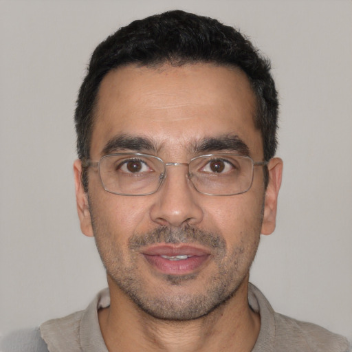 Joyful white adult male with short  black hair and brown eyes