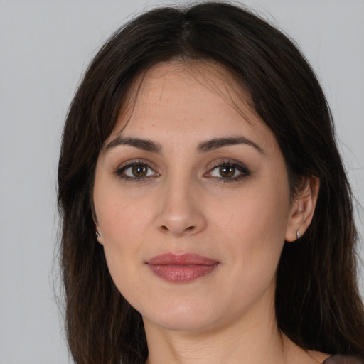 Joyful white young-adult female with long  brown hair and brown eyes