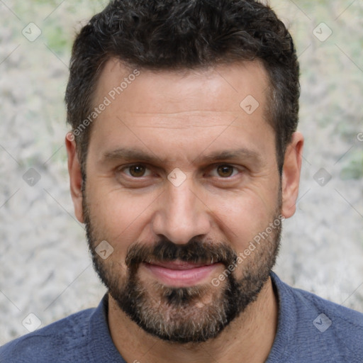 Joyful white adult male with short  black hair and brown eyes