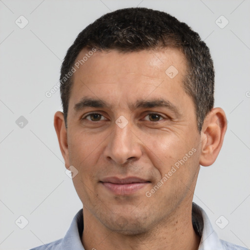 Joyful white adult male with short  black hair and brown eyes