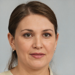 Joyful white adult female with medium  brown hair and brown eyes
