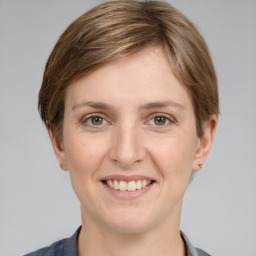 Joyful white young-adult female with medium  brown hair and grey eyes