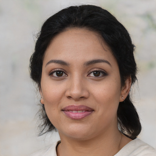 Joyful latino young-adult female with medium  black hair and brown eyes