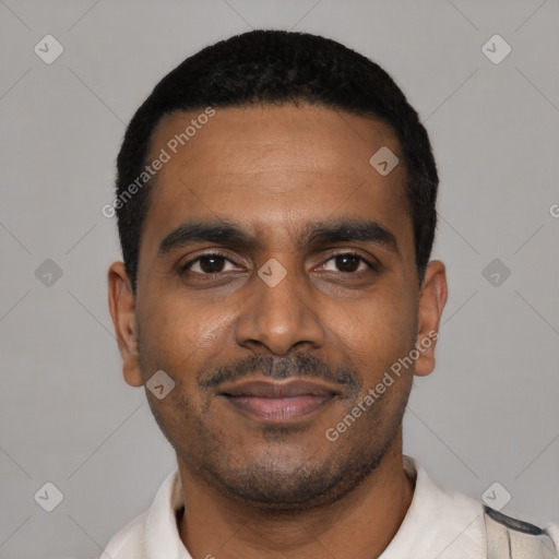 Joyful black young-adult male with short  black hair and brown eyes
