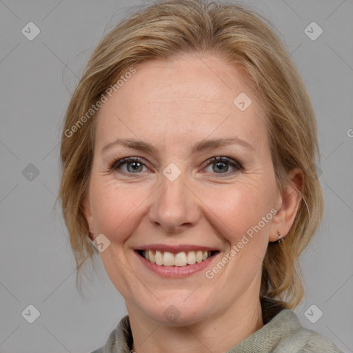 Joyful white adult female with medium  brown hair and blue eyes