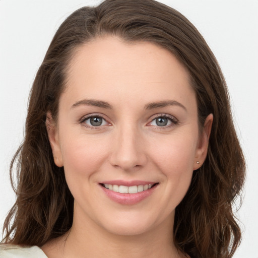 Joyful white young-adult female with long  brown hair and grey eyes