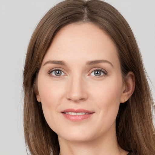 Joyful white young-adult female with long  brown hair and grey eyes