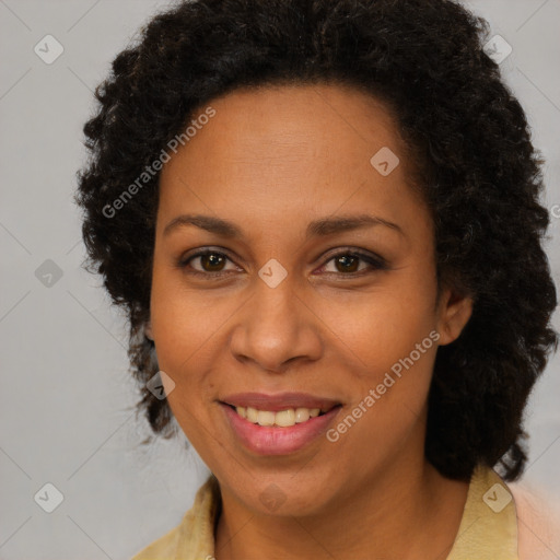 Joyful black adult female with medium  brown hair and brown eyes