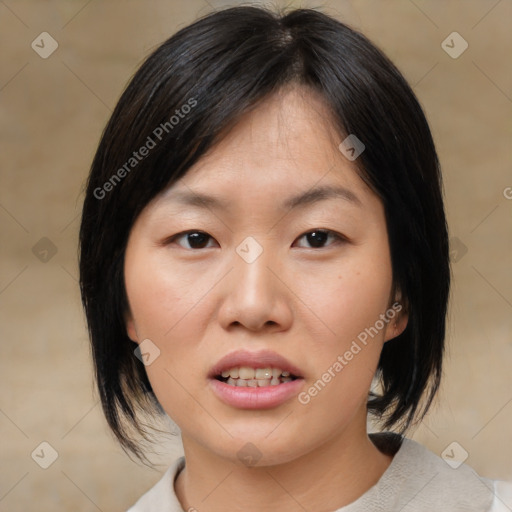 Joyful asian young-adult female with medium  black hair and brown eyes