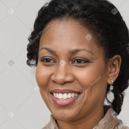 Joyful black adult female with medium  brown hair and brown eyes