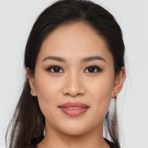 Joyful asian young-adult female with long  brown hair and brown eyes