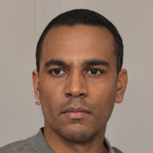 Neutral latino adult male with short  black hair and brown eyes