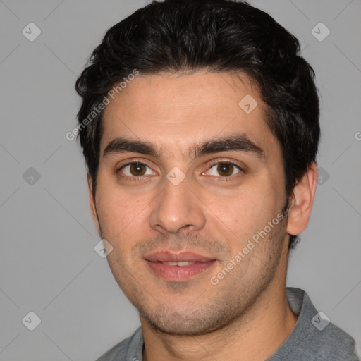 Joyful white young-adult male with short  black hair and brown eyes