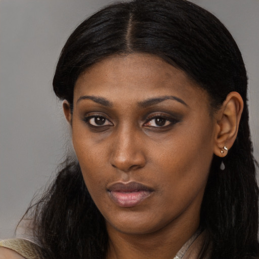 Neutral black young-adult female with long  brown hair and brown eyes