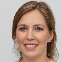 Joyful white adult female with medium  brown hair and grey eyes