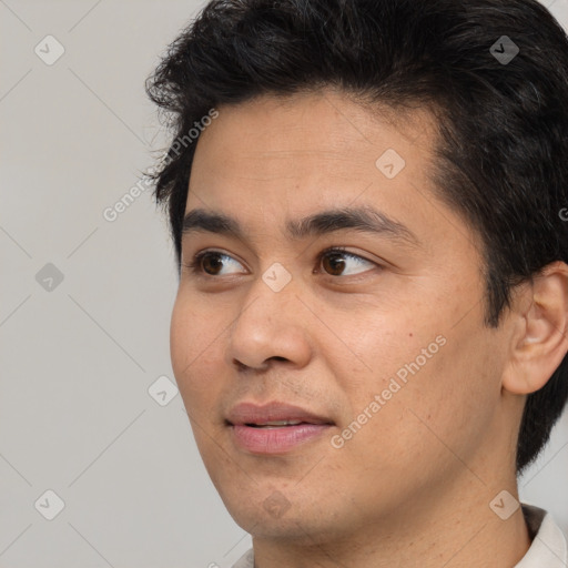 Joyful asian young-adult male with short  black hair and brown eyes