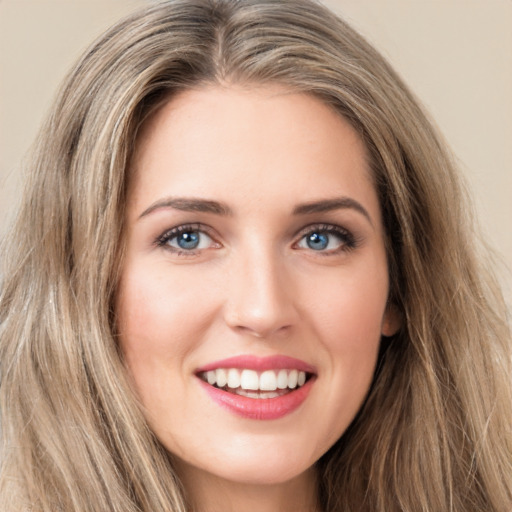 Joyful white young-adult female with long  brown hair and green eyes