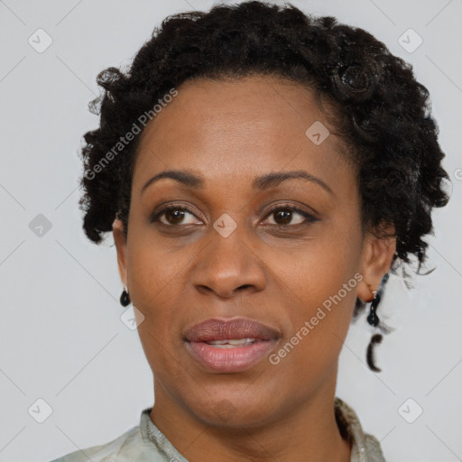 Joyful black adult female with short  brown hair and brown eyes