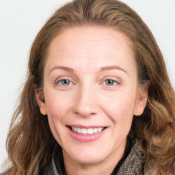 Joyful white young-adult female with long  brown hair and blue eyes