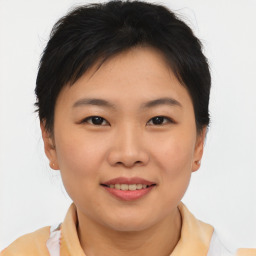 Joyful asian young-adult female with short  brown hair and brown eyes