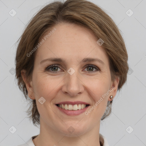 Joyful white adult female with medium  brown hair and grey eyes