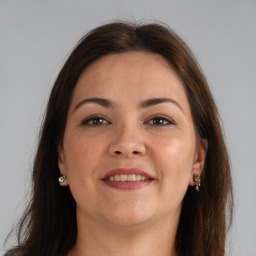 Joyful white young-adult female with long  brown hair and grey eyes