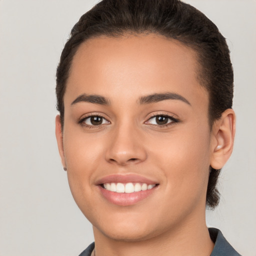 Joyful white young-adult female with short  brown hair and brown eyes