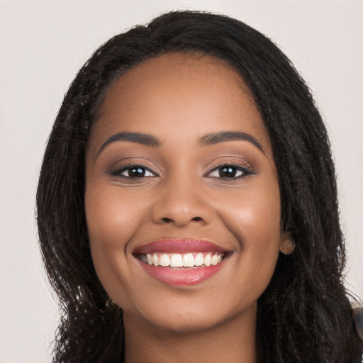 Joyful white young-adult female with long  black hair and brown eyes