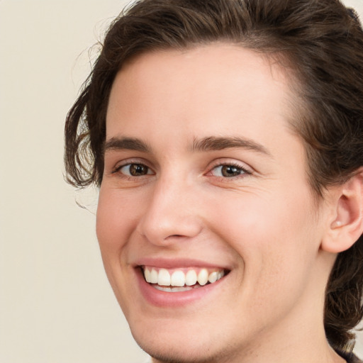 Joyful white young-adult female with medium  brown hair and green eyes