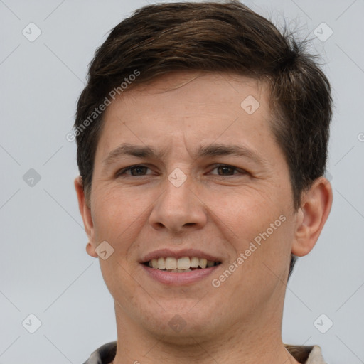 Joyful white adult male with short  brown hair and brown eyes