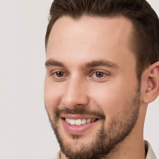 Joyful white young-adult male with short  brown hair and brown eyes