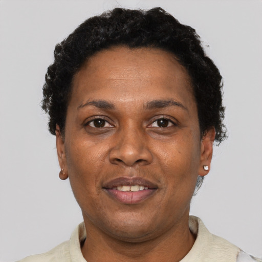 Joyful black adult female with short  black hair and brown eyes