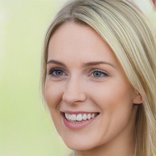 Joyful white young-adult female with long  brown hair and blue eyes