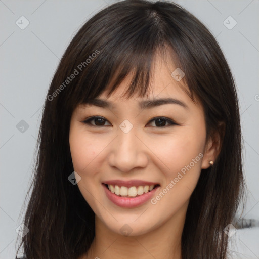 Joyful asian young-adult female with long  brown hair and brown eyes