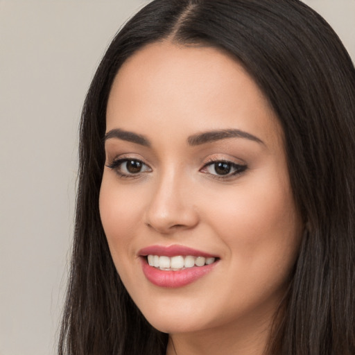 Joyful white young-adult female with long  black hair and brown eyes