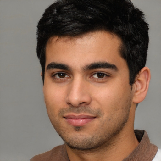Joyful white young-adult male with short  black hair and brown eyes