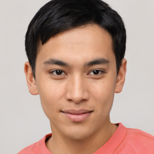 Joyful asian young-adult male with short  black hair and brown eyes