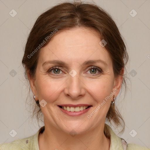 Joyful white adult female with medium  brown hair and grey eyes