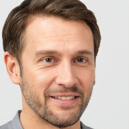 Joyful white adult male with short  brown hair and brown eyes