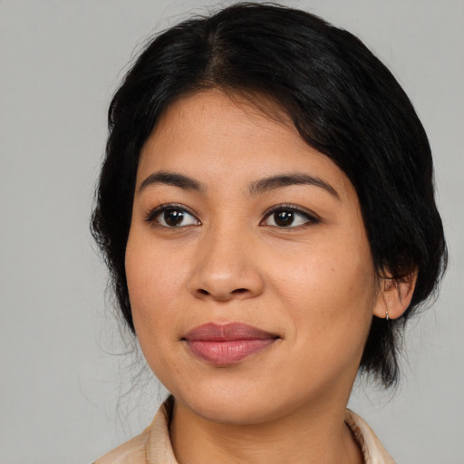 Joyful asian young-adult female with medium  black hair and brown eyes