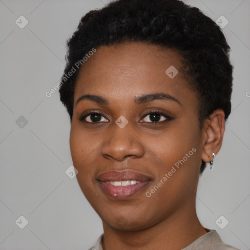 Joyful black young-adult female with short  black hair and brown eyes