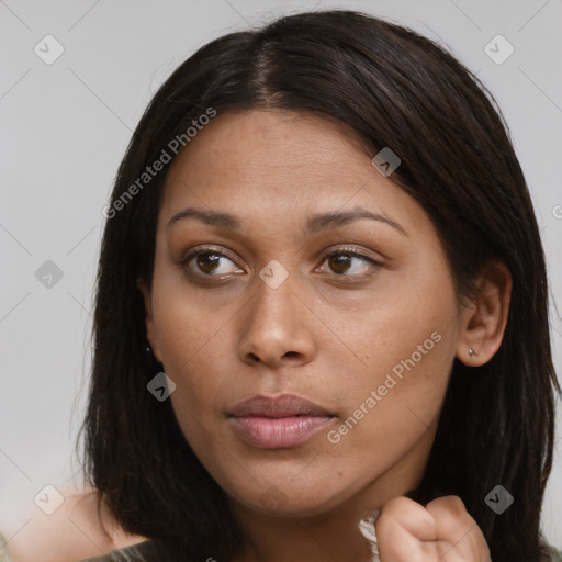 Joyful black young-adult female with long  brown hair and brown eyes