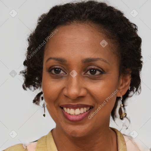 Joyful black adult female with medium  brown hair and brown eyes