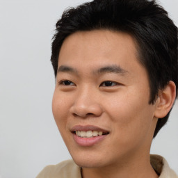 Joyful asian young-adult male with short  black hair and brown eyes